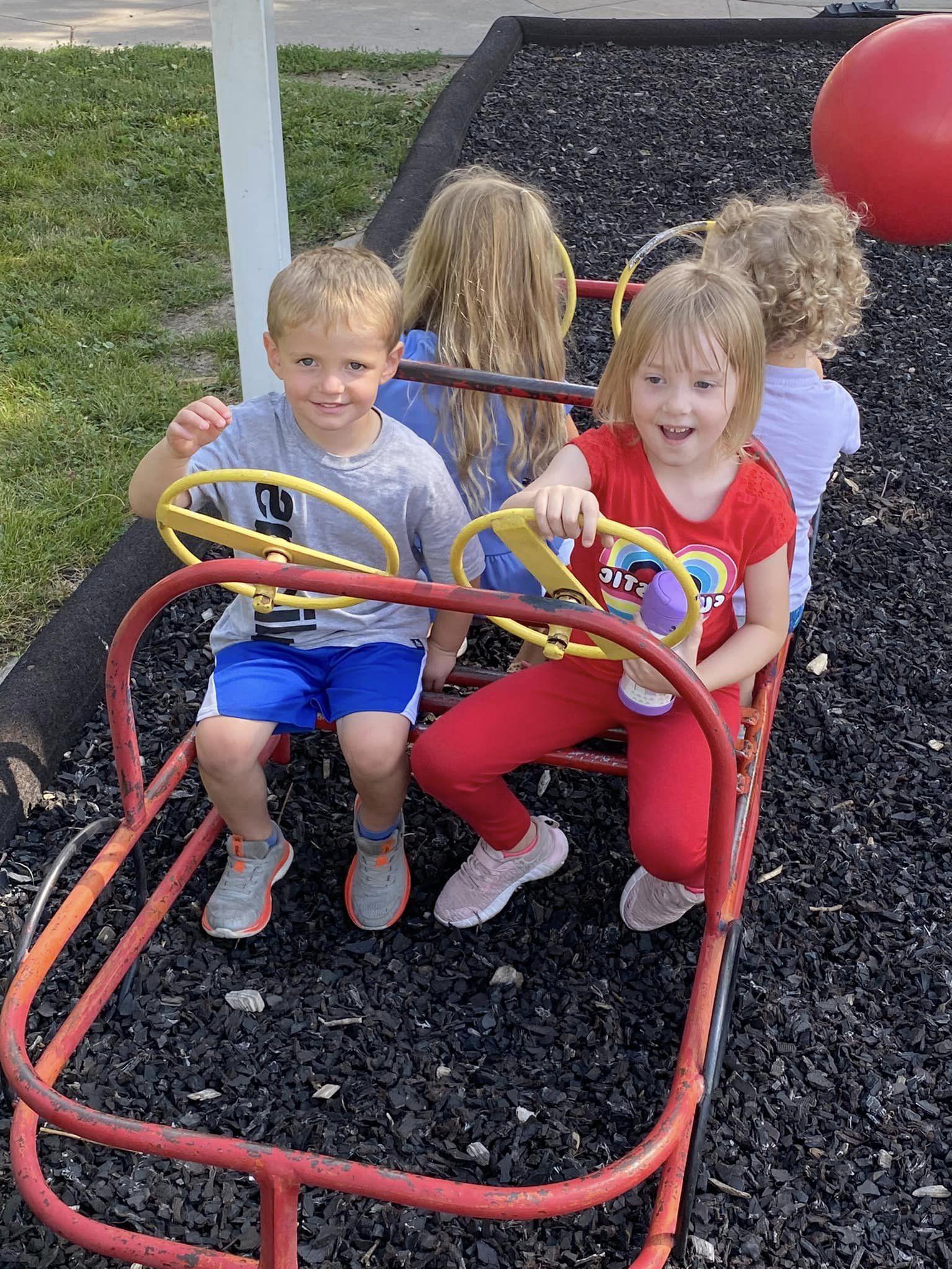 A group of children play outside the Child Development Center